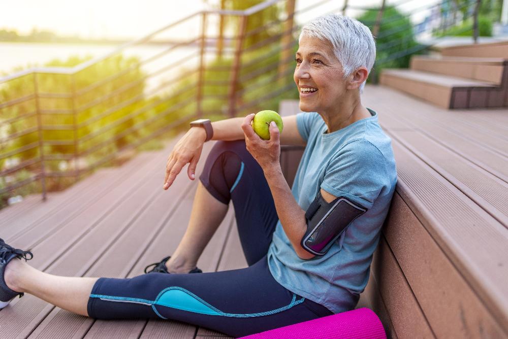 woman eating apple with dental implants